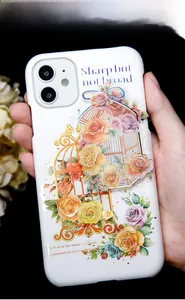 Detail of floral PET stickers with gold accents applied on a white iPhone case