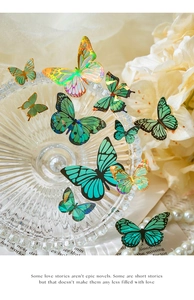 Macro detail of translucent butterfly stickers with gold foil edges and laser finish