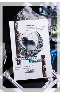 Detail of a black cat silhouette on a crescent moon PET sticker with laser effect finish