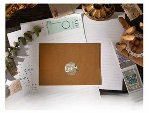 Close-up of vintage brown kraft envelope with Miss You seal sticker and retro stationery