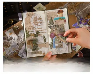 Macro shot of vintage nature stickers with butterflies and plants on a rustic wooden desk