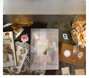 Detailed flat lay of vintage nature-themed stickers and scrapbooking paper set