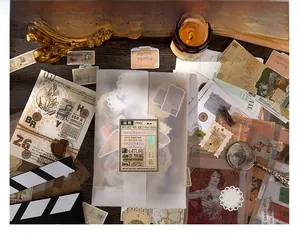 Vintage journal scrapbooking kit with botanical stickers and retro paper on a styled desk