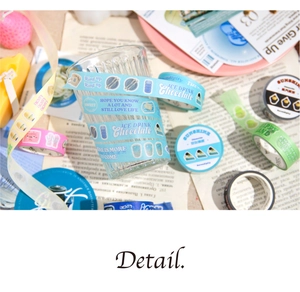 Close-up of creative illustrative washi tapes applied on a glass cup for DIY scrapbooking