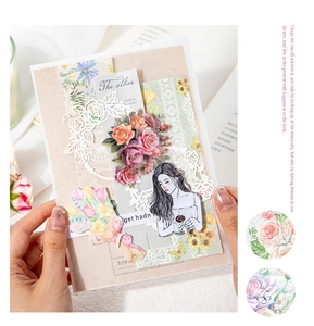Close-up of vintage floral lace paper materials and figure stickers for scrapbooking