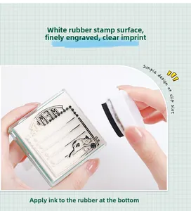 Macro detail of cat-themed clear stamp showing fine carving and ink application process