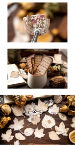 Dettaglio macro di carte scrapbooking vintage con stampe botaniche e motivi di spartiti
