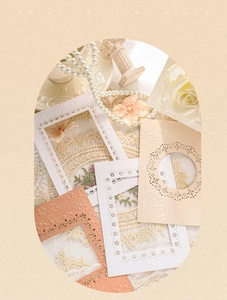 Detail of embossed hollow paper frames with floral laser-cut edges in cream tones