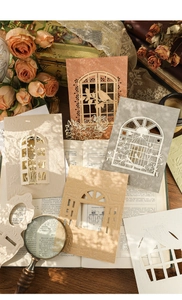Detailed laser-cut paper scrapbooking cards with vintage European window and floral motifs