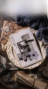 Detailed close-up of vintage butterfly stickers and floral patterned scrapbooking papers