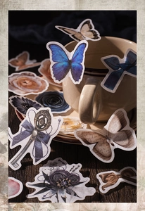Detail of vintage aesthetics stickers featuring butterflies, flowers and antique keys