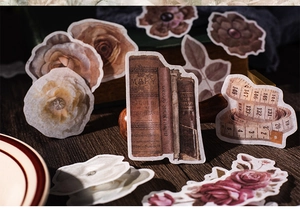 Detail of vintage scrapbooking stickers with rose patterns and antique book designs