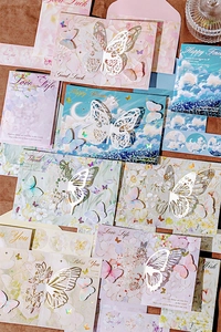 Detailed overhead view of 3D cutout butterfly greeting cards with matching envelopes
