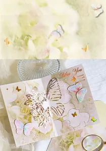 Close-up of laser-cut floral details and gold foil butterfly greeting card with envelope