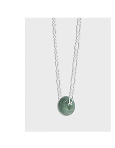 Detail showing a silver Figaro chain necklace with a circular green jade pendant