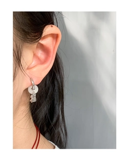 Detail of S925 silver hoop earring with white jade bead and Fu character pendant