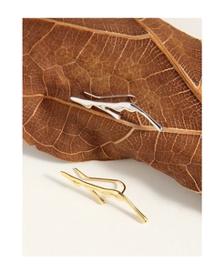 Detailed shot of irregular molten lava earrings in gold and silver finishes