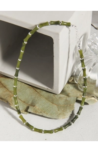 Macro detail of natural olive jade bamboo necklace with S925 sterling silver beads