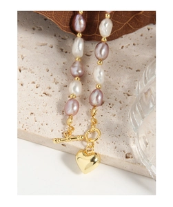 Detail of baroque pearl necklace with gold heart pendant and toggle clasp closure