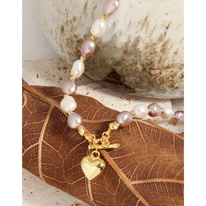 Baroque pearl necklace with pink purple tones and gold heart pendant with toggle clasp