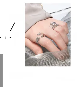 Detail of silver S925 rings set featuring irregular vine shape and moonstone bead band