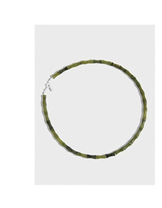 Detailed macro shot of green bamboo-shaped bead necklace with silver metal clasp