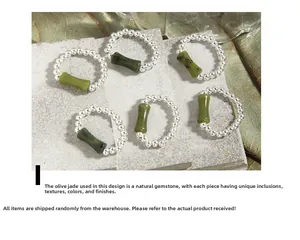 Macro detail of olive jade bamboo joints and silver bead elastic rings on stone