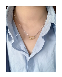 Macro view of geometric U-shaped two-tone link necklace in gold and silver finish