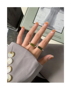 Macro detail of S925 silver beaded stretch ring with green bamboo style accents