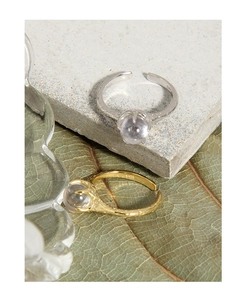 Detailed view of S925 silver and gold rings with irregular texture and cubic zirconia