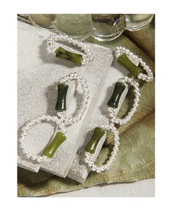Close-up of S925 silver beaded elastic ring with green bamboo-shaped jade on stone slabs