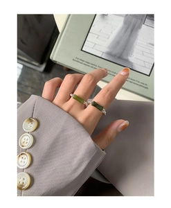 Detail of S925 silver beaded ring featuring green bamboo-shaped nodes on a female finger