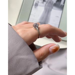 Irregular S925 silver ring with geometric folds and an oval purple gemstone