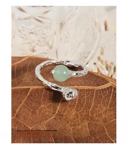 Detailed view of S925 silver ring with Aventurine stone on a dry leaf background