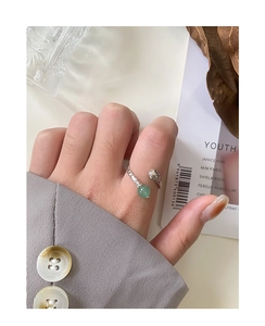 Close-up of S925 silver ring featuring green aventurine bead and carved rose detail
