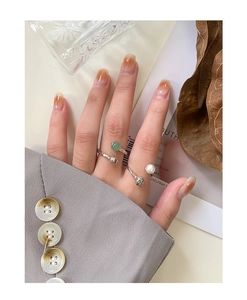 Detailed view of S925 silver open rings with green aventurine and elegant pearl charms