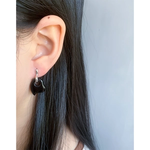Minimalist S925 silver heart stud earrings with black onyx on a female model's ear