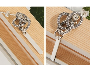 Macro detail of S925 sterling silver snake texture wrap earring with polished rectangle tag