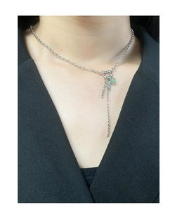 Close-up of S925 silver Y-necklace with green aventurine bead on black blazer