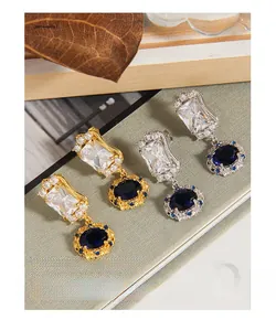Detail of luxury S925 silver earrings with blue gemstones and micro-pave zircons