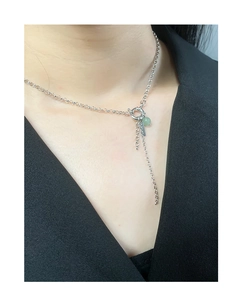 Detail of S925 silver necklace featuring a green stone pendant and chain tassels