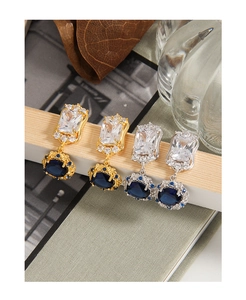 Detail of vintage court style earrings with blue zircon and pavé crystal accents