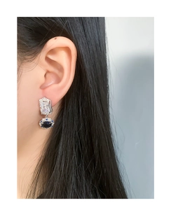 Macro detail of vintage palace style earrings with blue and white micro-set zircon
