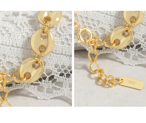 Detailed macro view of S925 sterling silver stamp on gold coffee bean link bracelet