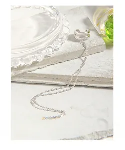 Detail of S925 sterling silver ear cuff featuring double bands and long fringe chain