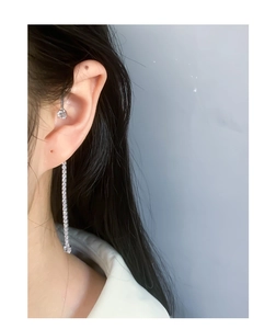 Macro shot of silver S925 tassel earrings with sparkling cubic zirconia on a model