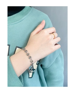 Macro detail of polished S925 sterling silver pig nose link bracelet on wrist