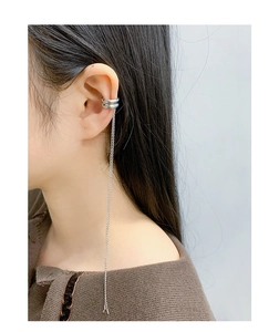 Detail of silver S925 geometric cuff earring with delicate tassel chain on model