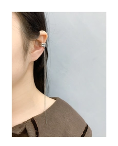 Detail of S925 sterling silver ear cuff with minimalist fringe chain on female model