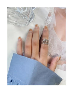 Close-up of S925 sterling silver multi-layer crossover ring on model's finger